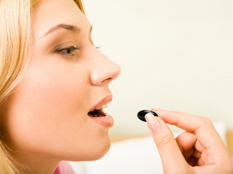 the girl takes pills to prevent worms